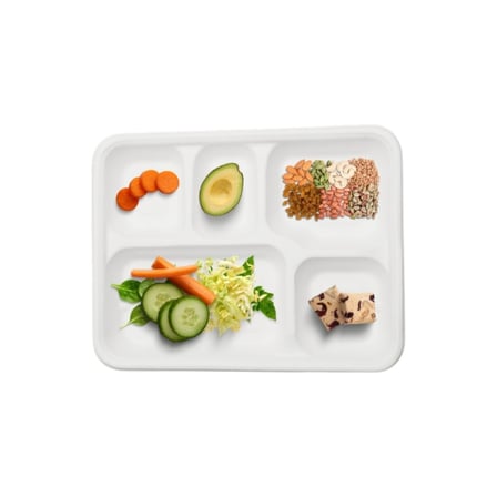 Compostable school lunch trays​ with five compartments holding fresh vegetables, avocado & mixed nuts.jpg