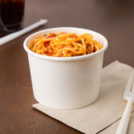 12 oz food cup made of white paper containing spaghetti, with a fork ready for eating