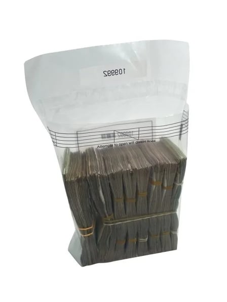 A transparent 6" x 9" cash transmittal bag filled with stacked bundles of cash, showing a secure seal warning.jpg