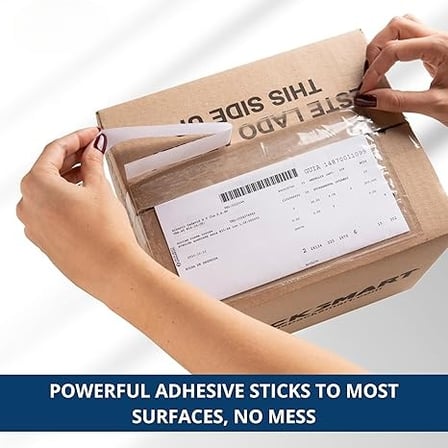 A person's hands are sealing a clear top-loading packing list envelope on a box