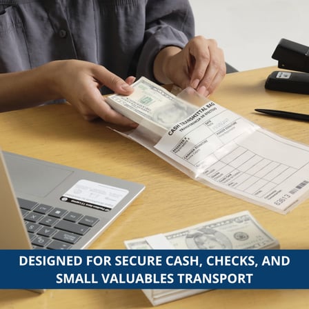 A person placing cash into a secure 8.5" x 8" cash transmittal bag on a desk.jpg