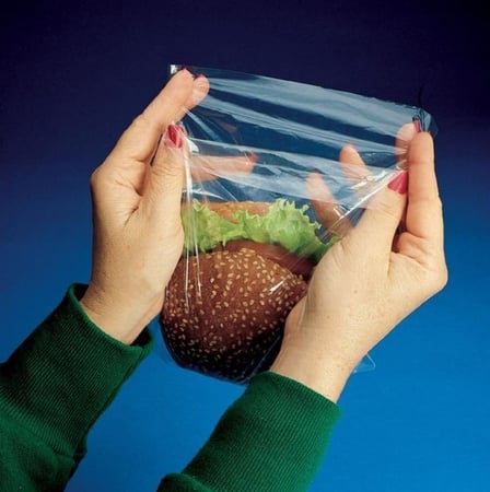 Hands holding a 7 X 7 + 1 12 LDPE plastic flip top sandwich bag.jpg
