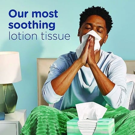 Person Using a Tissue from a Puffs Plus Lotion Facial Tissue Box.jpg