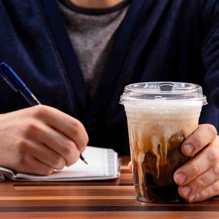 Person Holding an Solo Prima Clear PET Plastic Cold Cup with Strawless Lid.jpg